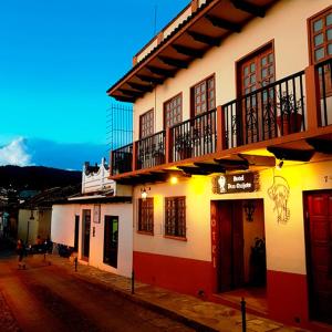 a building with a balcony on the side of a street at Hotel Don Quijote in San Cristóbal de Las Casas