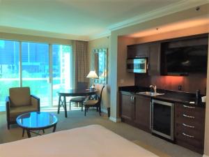 a living room with a kitchen and a dining room at MGM Signature Condo Hotel by Owner - No Resort Fee !! in Las Vegas