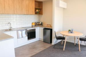 a small kitchen with a table and a table and chairs at Fivestone Suite in Lake Tekapo