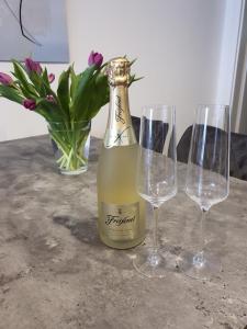 a bottle of wine and two wine glasses on a table at Apartment Airport Cologne in Cologne