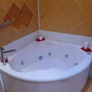 a white bath tub sitting next to a white toilet at Hotel Manzoni Wellness&Spa in Montecatini Terme