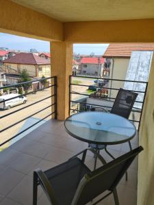 a balcony with a table and two chairs and a view at Vila Adina in Eforie Nord