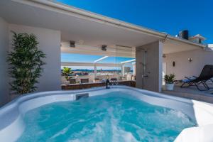 a jacuzzi tub in a house with a patio at Penthouse with roof terrace with jacuzzi in Zadar