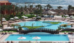 an aerial view of a resort with two pools and a bridge at Sharm Grand Plaza Resort - Families and Couples Only in Sharm El Sheikh