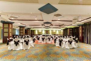 a banquet hall with white tables and chairs at Park Town Hotel in Saskatoon +57 photos