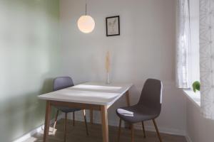 a room with a table, chair and a lamp at Lindvig Ferie - Danhostel Nymindegab in Nymindegab