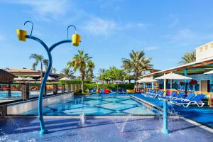 a pool at a resort with chairs and umbrellas at Rixos Bab Al Bahr - Ultra All Inclusive in Ras al Khaimah +37 photos