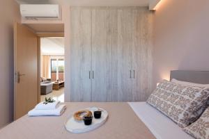 a bedroom with a bed with a tray of food on it at Lia's Home Two in Mantoúkion