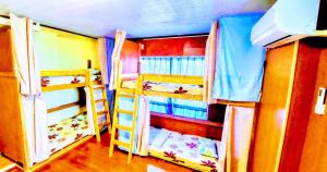 a room with two bunk beds and a room with at Guest House Yun Terrace in Ishigaki Island