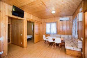 a dining room with a table and chairs in a room at Camping Los Llanos in Denia