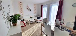 a living room with a table and a dining room at Fewo Traum in Neppermin