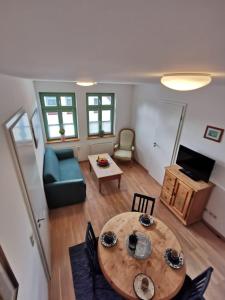 a living room with a table and a couch at Kornmühle Appartment Gabi in Mellenthin