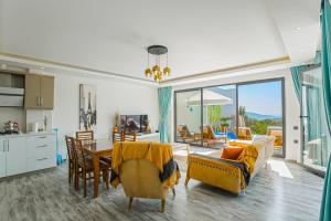 a kitchen and living room with a table and chairs at VillA Evreni in Kaş