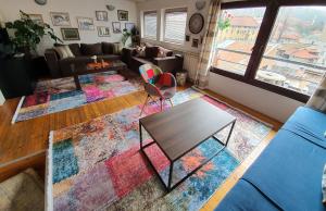 a living room with a table and a couch at Apartment Noah in Sarajevo