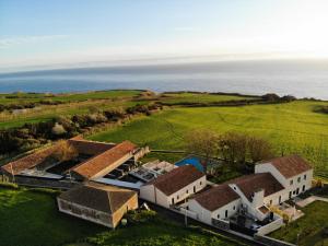 an aerial view of a house with the ocean in the background at SENSI Azores Nature and SPA in Ginetes