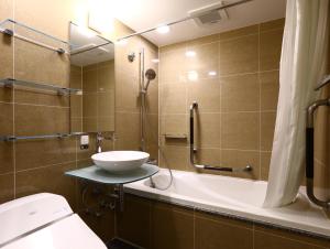 a bathroom with a sink and a shower and a toilet at APA Hotel Ginza Shintomicho Ekimae Kita in Tokyo