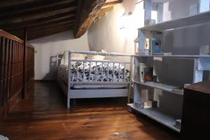 a room with a bunk bed and a wooden floor at Antiche Fonti in Bibbona
