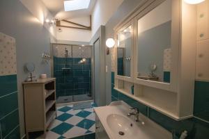 a bathroom with a tub and a sink and a shower at l'Atelier Chambourdin - Maison/Loft Centre Blois in Blois +33 photos