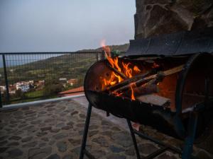 a fire in a fire pit with a view at Aretis sea view house in Pachyammos