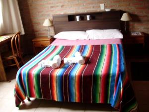 Una cama o camas en una habitación de Atahualpa mi Posada