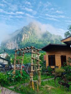 a house with a mountain in the background at Golden Jungle House in Ha Giang