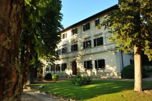 a large white building with trees in front of it at La Villa di Caiano in Londa