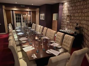 a long dining room with a long table and chairs at The Castle Inn in Dirleton