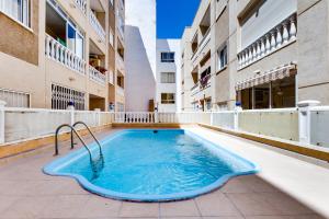 a swimming pool in the middle of a building at Apartment Cura Beach GALERA in Torrevieja