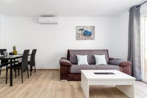 a living room with a couch and a table at Apartment Cura Beach GALERA in Torrevieja