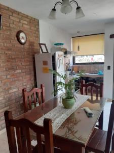 a kitchen with a dining table and a refrigerator at Los algarrobos in Villa Carlos Paz