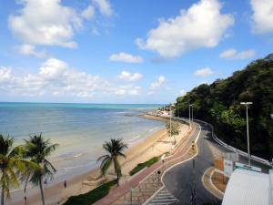 a view of a beach with palm trees and the ocean at Blue Sunset Flats Beira Mar - Apt 217 in João Pessoa