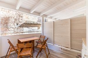 a dining room with wooden chairs and a table at The Bell in Comiso