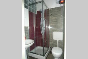 a bathroom with a shower and a toilet and a sink at "Little Sicilian Home"-room with a private bathroom & kitchen -fridge - and shared a beautiful terrace on Hostel Taormina Center in Taormina +15 photos