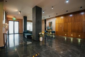 a lobby with a couch and a chair in a building at Fabesca Boutique Hotel & SPA in Sovata +265 photos