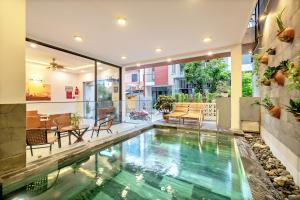 a house with a swimming pool in the middle of it at Tam Hong Phuc Homestay Hoi An in Hoi An
