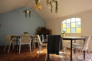 a dining room with tables and chairs and a window at Agroturystyka Gardna Wielka in Gardna Wielka