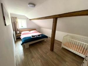מיטה או מיטות בחדר ב-Apartmány Rosenberg