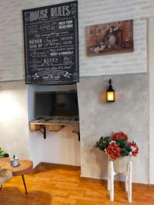 a restaurant with a menu on the wall and a table with flowers at La Dependance b&b in Campobasso
