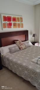 a bedroom with a bed with two pillows on it at Ground floor with view by Bev in San Javier +18 photos