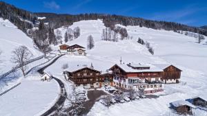 an aerial view of a lodge in the snow at Pension Seighof in Saalbach Hinterglemm
