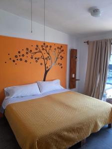 a bedroom with a bed with a tree with birds on it at Posada Casa Topiltzin in Tepoztlán +20 photos
