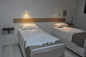 En eller flere senge i et værelse på Hotel Chalet Monet - Granja Vianna