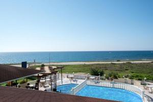 a view of a swimming pool and the ocean at Katerina Hotel in Kanali