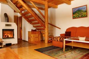 a living room with a couch and a fireplace at Chata Donovaly Bully 242/B in Donovaly