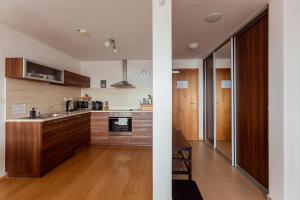 a kitchen with wooden cabinets and a counter top at Ski IN-OUT Apartmán Donovaly in Donovaly