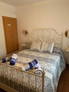 a bedroom with a bed with towels on it at CASA la PAU in Vilassar de Mar