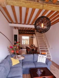 a living room with a blue couch and a staircase at Appartement Mes Amis Delft in Delft