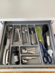a tray filled with utensils in a drawer at Papli Seaview Apartment in Pärnu