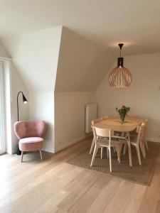 a dining room with a table and a chair at EastDune in Oostduinkerke