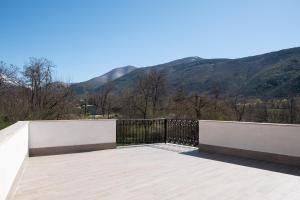a balcony with a fence and mountains in the background at "Il Miglio" Country House in Pettorano sul Gizio